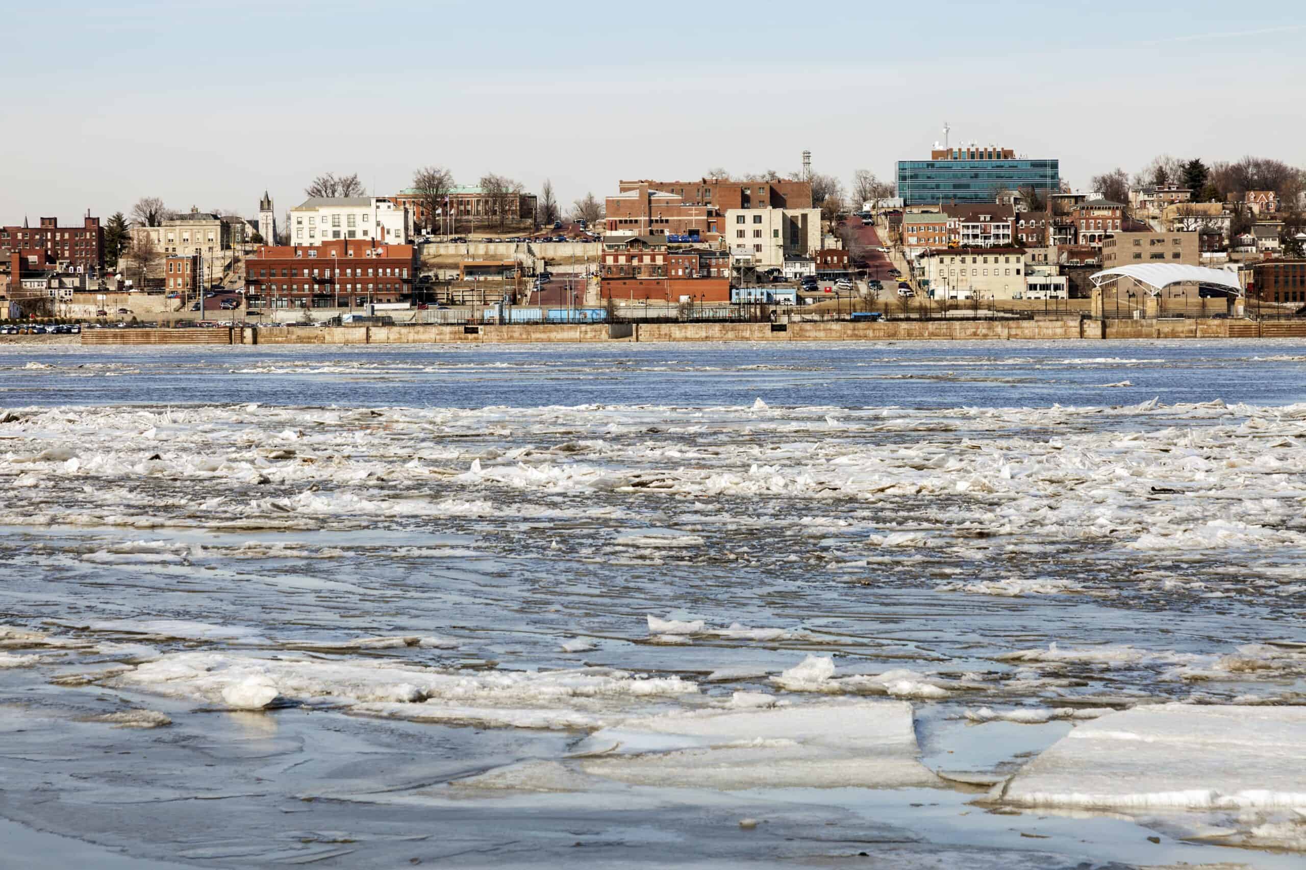 Winter view of the Alton, Illinois riverfront, featuring historic buildings and icy waters of the Mississippi River.